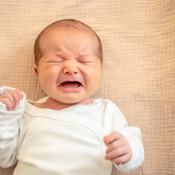 Newborn baby. Newborn baby girl crying.